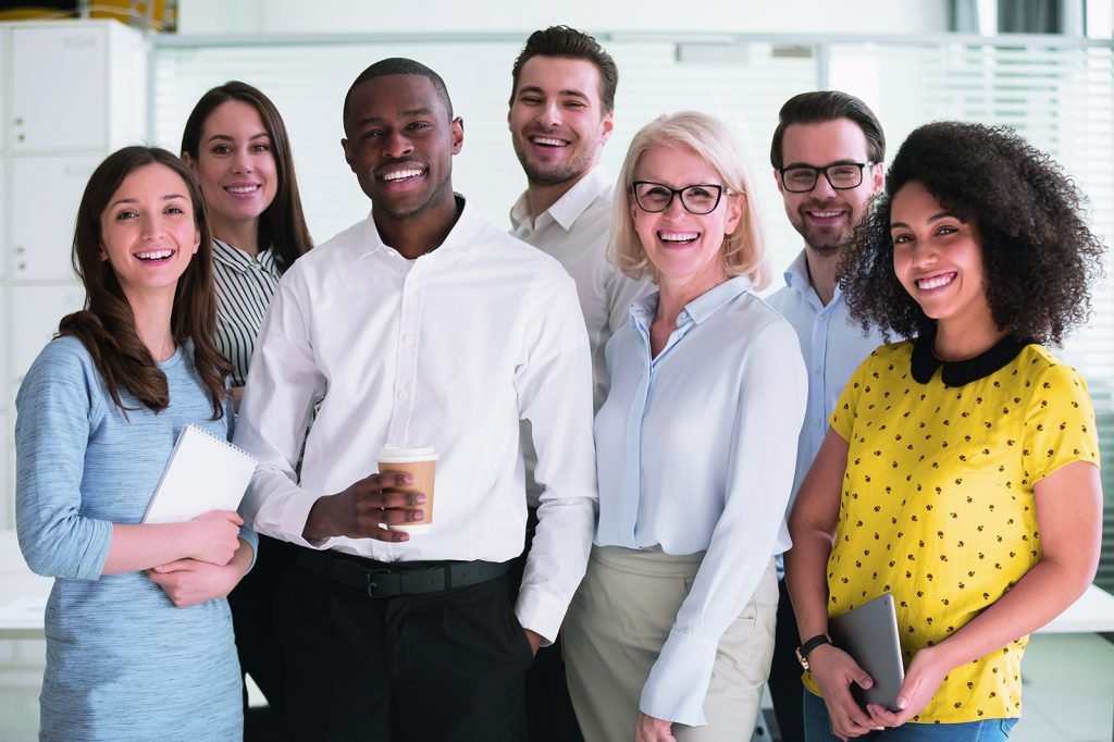 Positive multi racial corporate team posing looking at camera